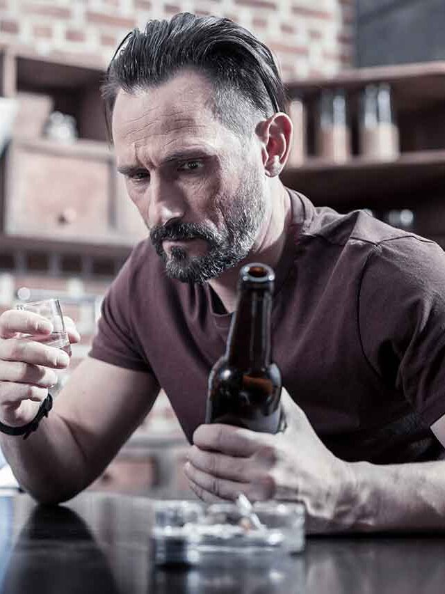 web-chronic-depression-cheerless-serious-depressed-man-holding-bottle-looking-it-while-drinking-alcohol-home