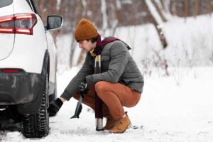 web-full-shot-man-checking-car-wheel